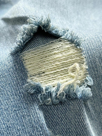 Distressed jeans on the front, lettering on the back